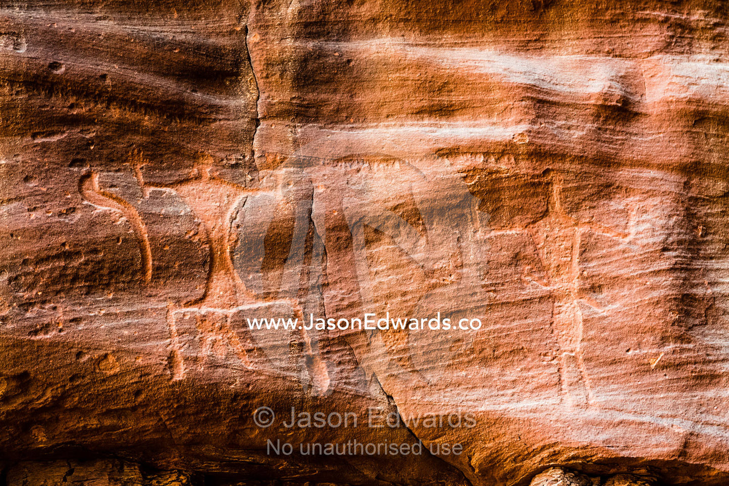 Petroglyphs depicting woman giving birth and an upright figure with raised arms. Wadi Rum, The Valley of the Moon, Jordan