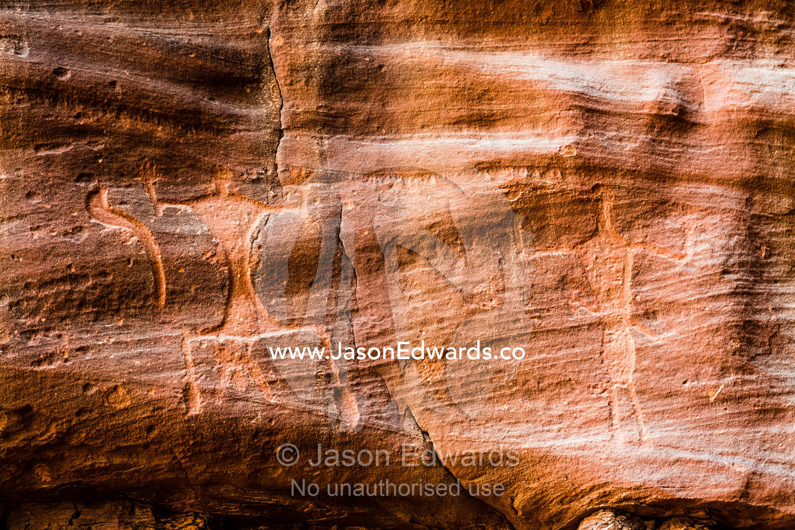 Petroglyphs depicting woman giving birth and an upright figure with raised arms. Wadi Rum, The Valley of the Moon, Jordan