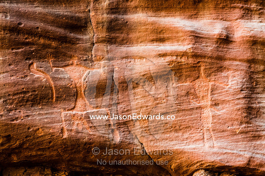 Petroglyphs depicting woman giving birth and an upright figure with raised arms. Wadi Rum, The Valley of the Moon, Jordan