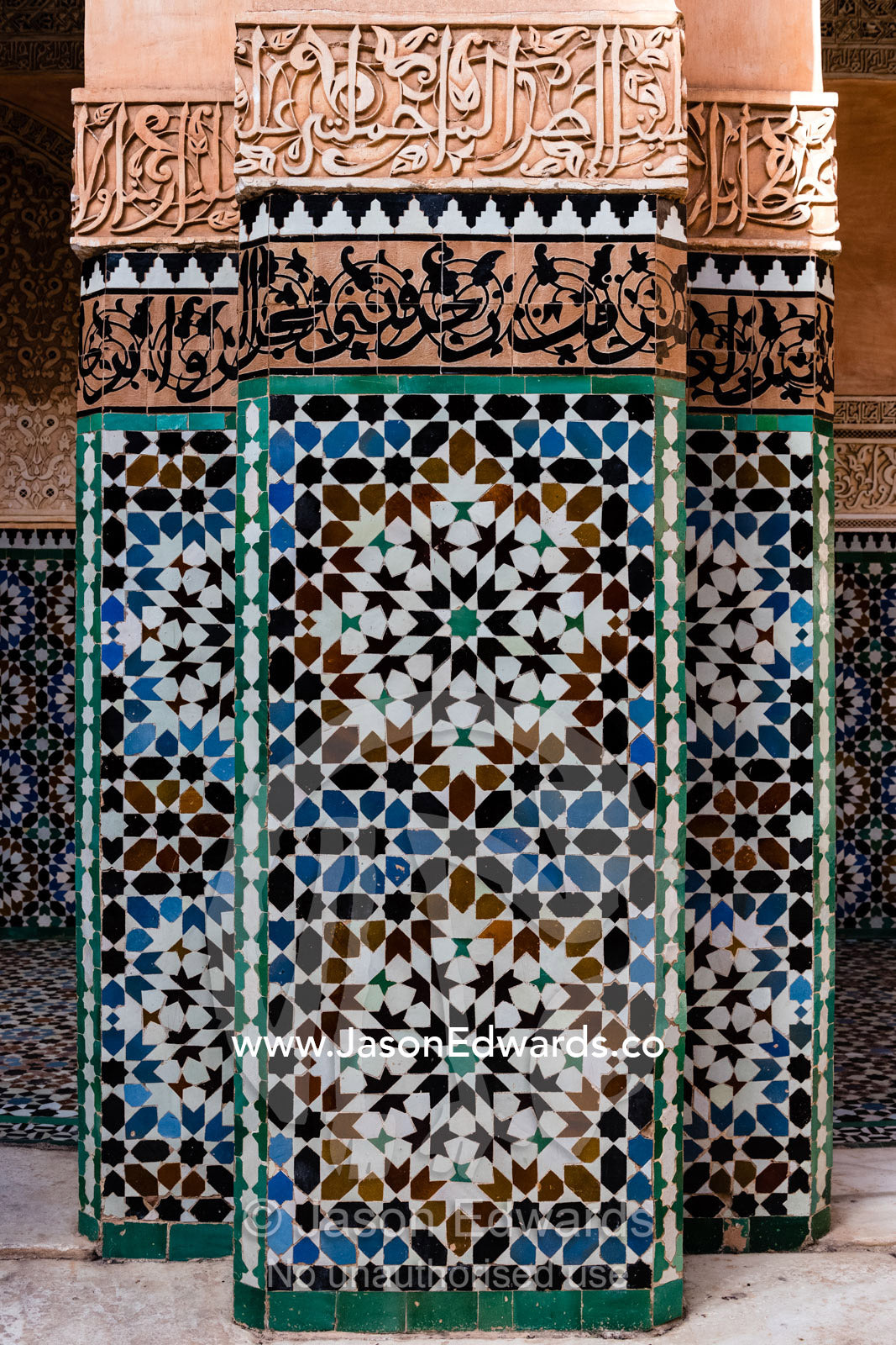 Geometric marble tiles create patterns on a pillar in a madrasa. Marrakech, Ben Youssef Madrasa, Morocco
