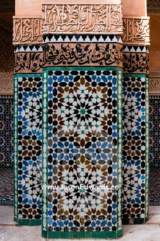 Geometric marble tiles create patterns on a pillar in a madrasa. Marrakech, Ben Youssef Madrasa, Morocco