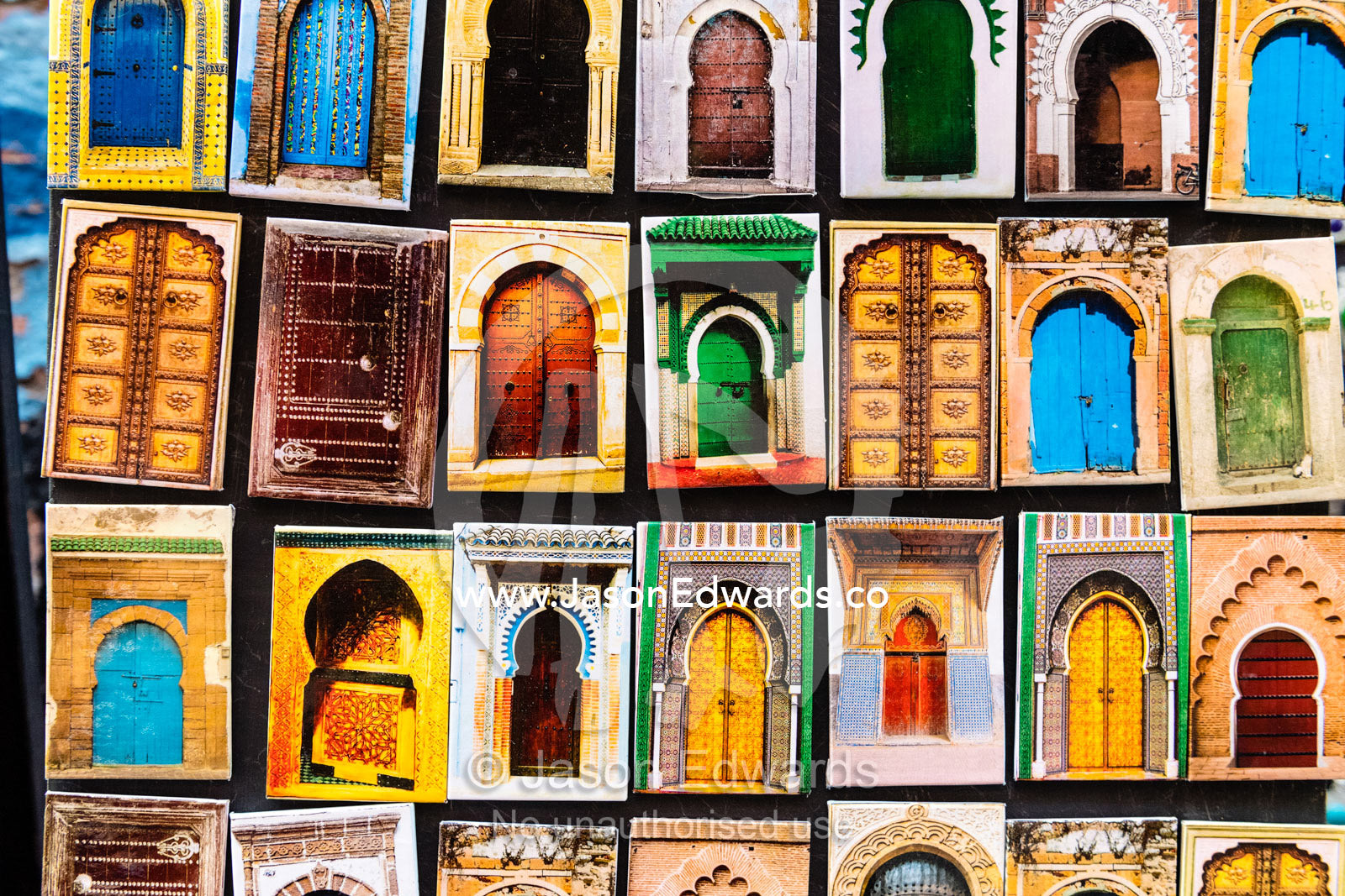 A collection of refrigerator magnets featuring colorful doors in Morocco. Marrakech, Marrakech Souk, Medina of Marrak, Morocco