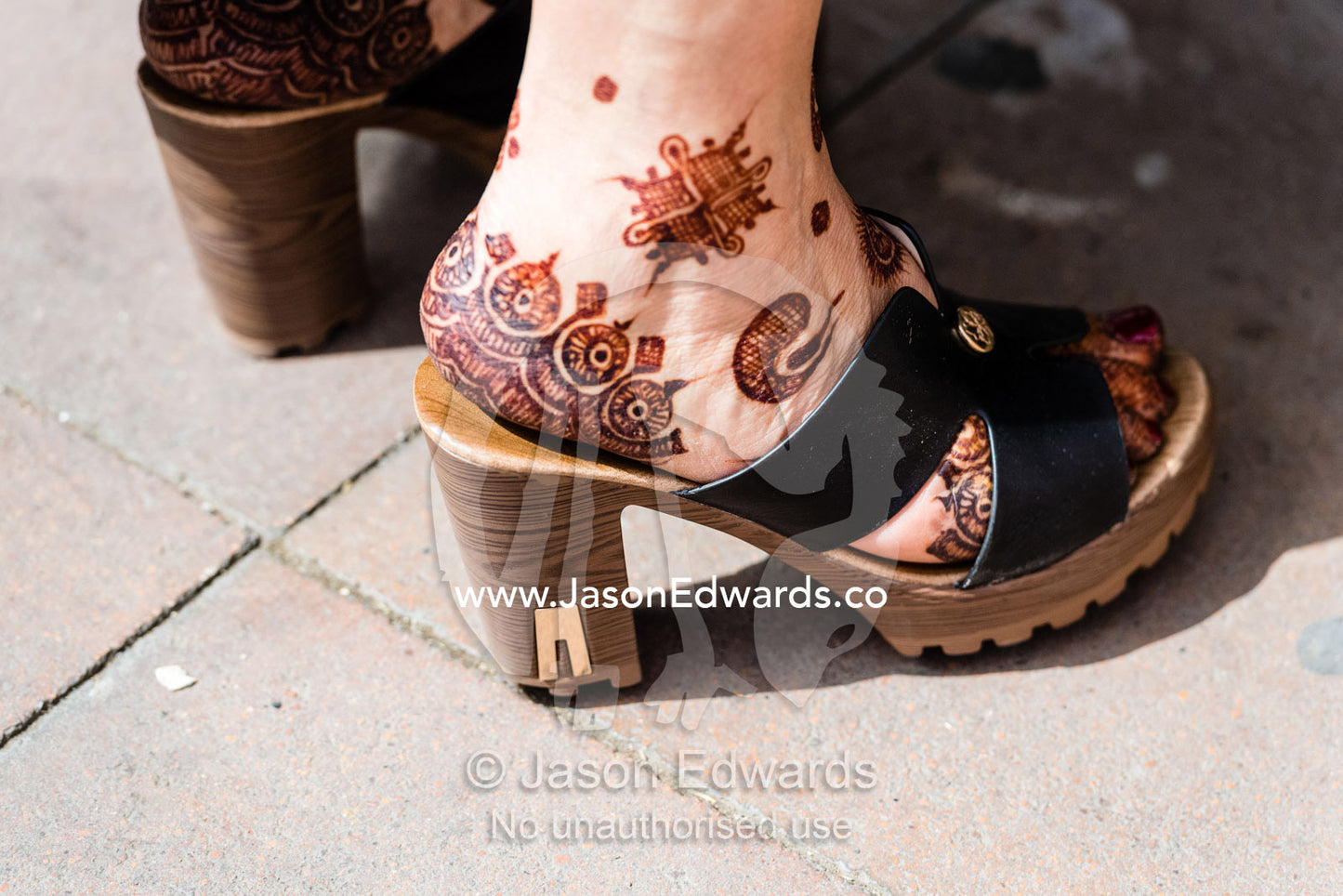 A woman wearing high heels with henna tattoos on her feet. Marrakech, Medina of Marrakech, Morocco