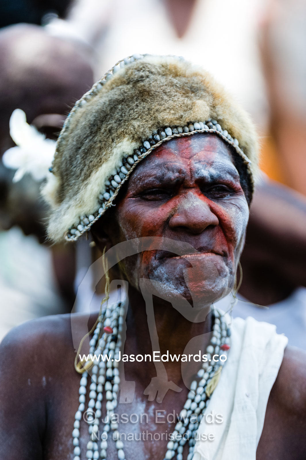 An Asmat woman wearing a hat made of shells and Spotted Cuscus fur. Syuru Village, Asmat Regency, Papua, Indonesia