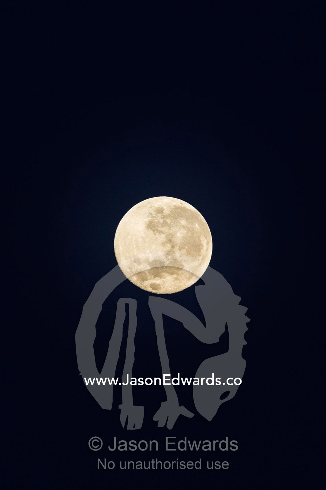 The craters and textures of a full moon in a night sky. Banda Neira, Banda Islands, West Papua, Indonesia