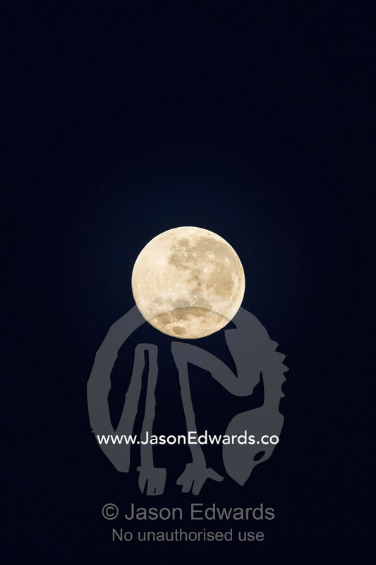 The craters and textures of a full moon in a night sky. Banda Neira, Banda Islands, West Papua, Indonesia