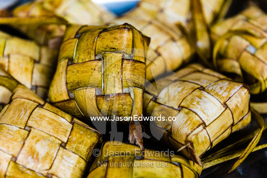 Banana leaf parcels containing rice for sale in an island market. Banda Neira, Banda Islands, West Papua, Indonesia