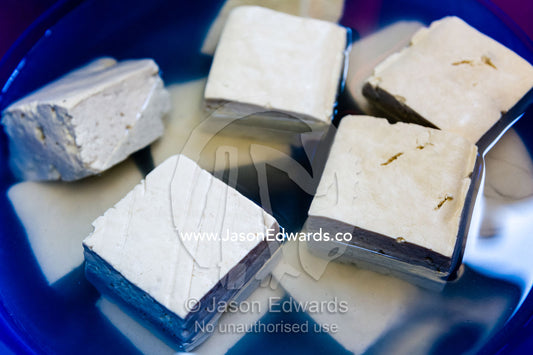 Tofu cubes in a bowl for sale in an island market. Banda Neira, Banda Islands, West Papua, Indonesia