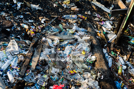 Plastic pollution and water bottles in a mound of rubbish on a riverbank in a town. Agats, Asmat Regency, Papua, Indonesia