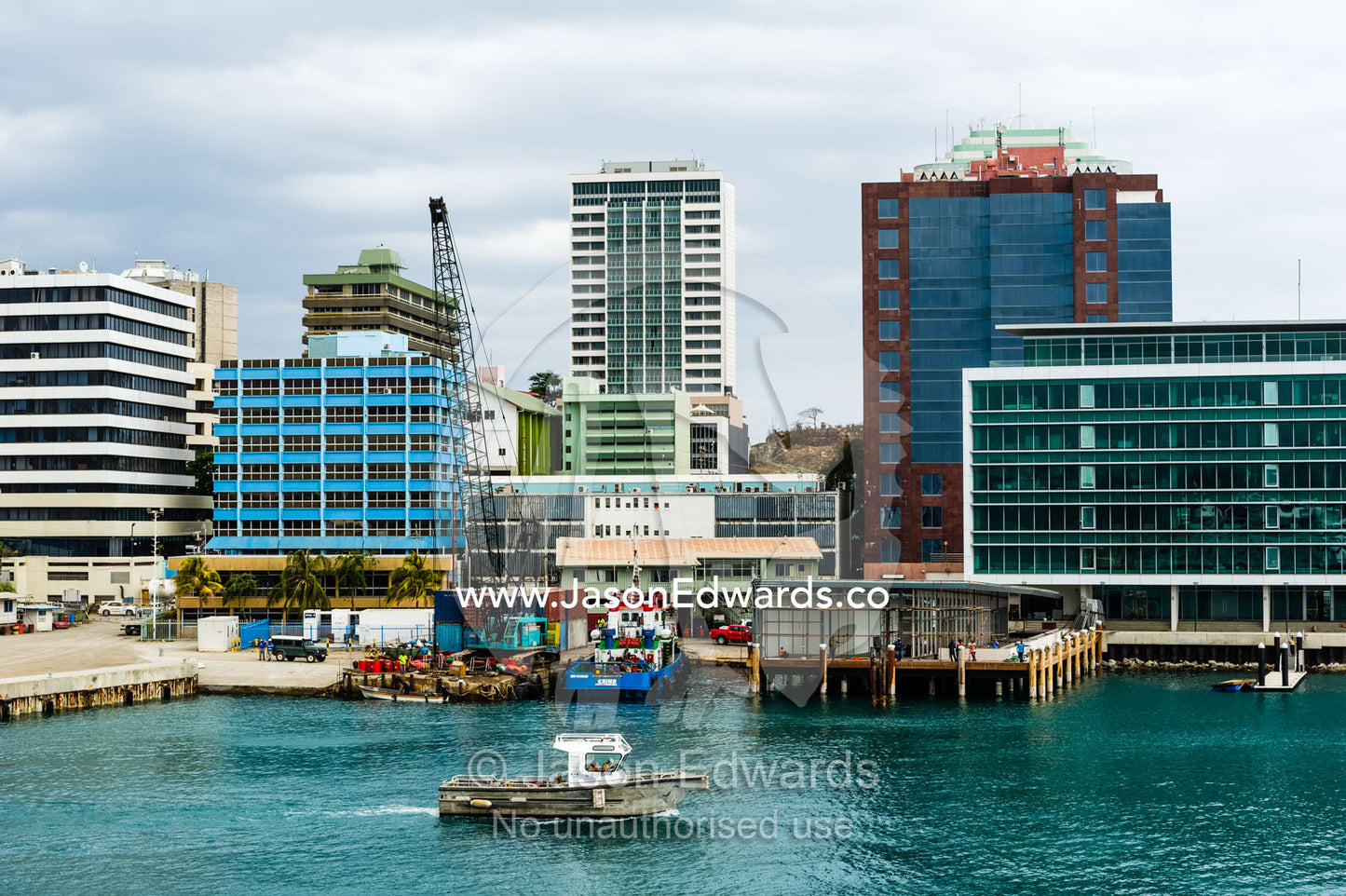 A fishing boat in the harbor beneath the central business district of Port Moresby. Port Moresby, Papuan Peninsula, National Capital District, Papua New Guinea