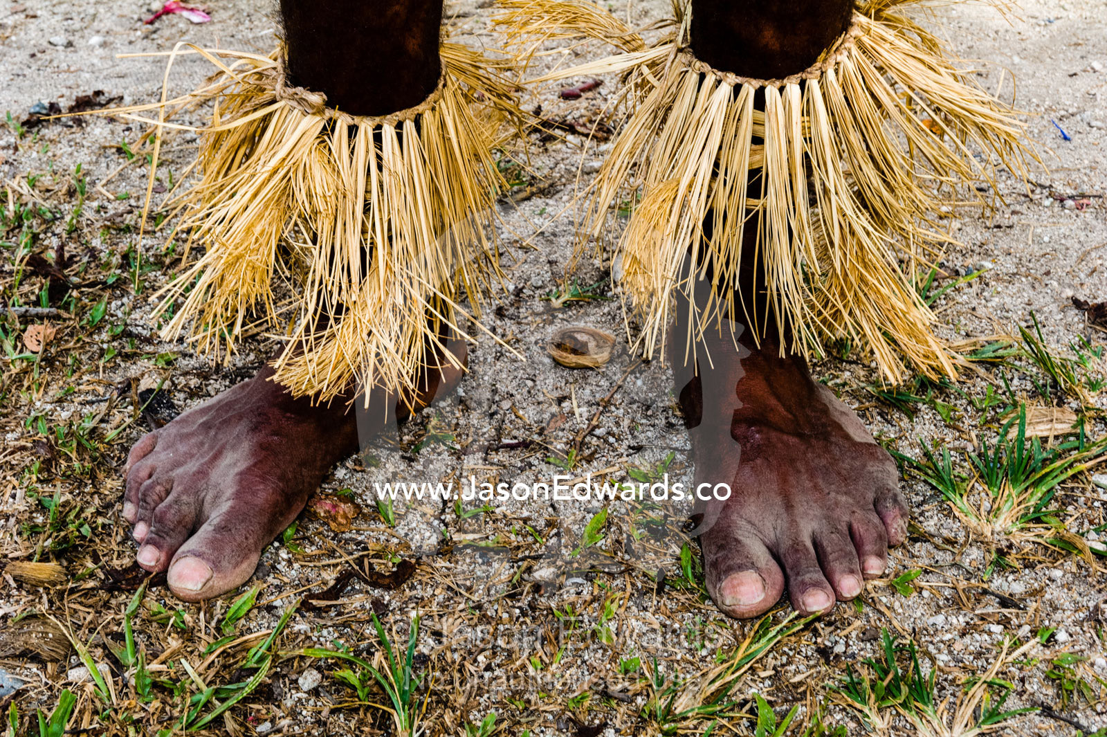 A Samarai warrior wearing grass ankle gaiters in a tribal ceremony. Samarai Island, Orangerie Bay, Milne Bay Province, Papua New Guinea