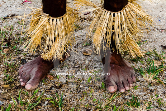 A Samarai warrior wearing grass ankle gaiters in a tribal ceremony. Samarai Island, Orangerie Bay, Milne Bay Province, Papua New Guinea