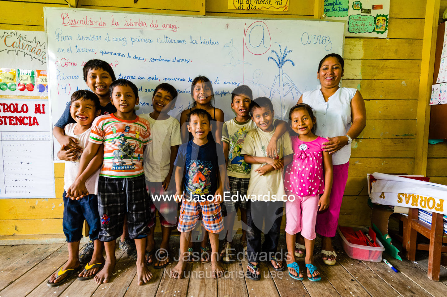 A teacher and her students in a school classroom in an Amazon village. Boca Pariamanu Native Community, Madre de Dios Region, Peru