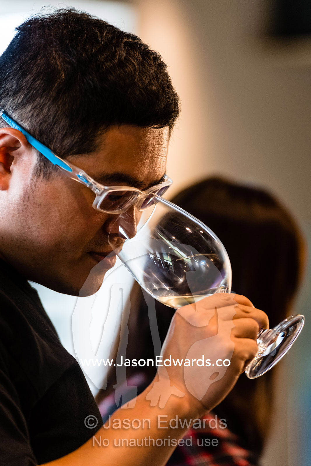 A man samples the aroma of a glass of wine at a wine tasting. Rosslyn Park, Adelaide, South Australia, Australia