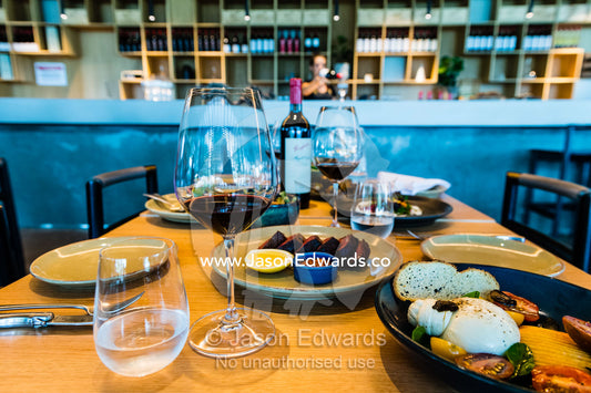 A lunch table set with fine wines and gourmet food in a winery restaurant. Rosslyn Park, Adelaide, South Australia, Australia