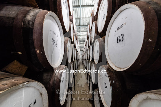 An enormous collection of wine barrels stacked and stored in a shed to age and mature. Nuriootpa, South Australia, Australia