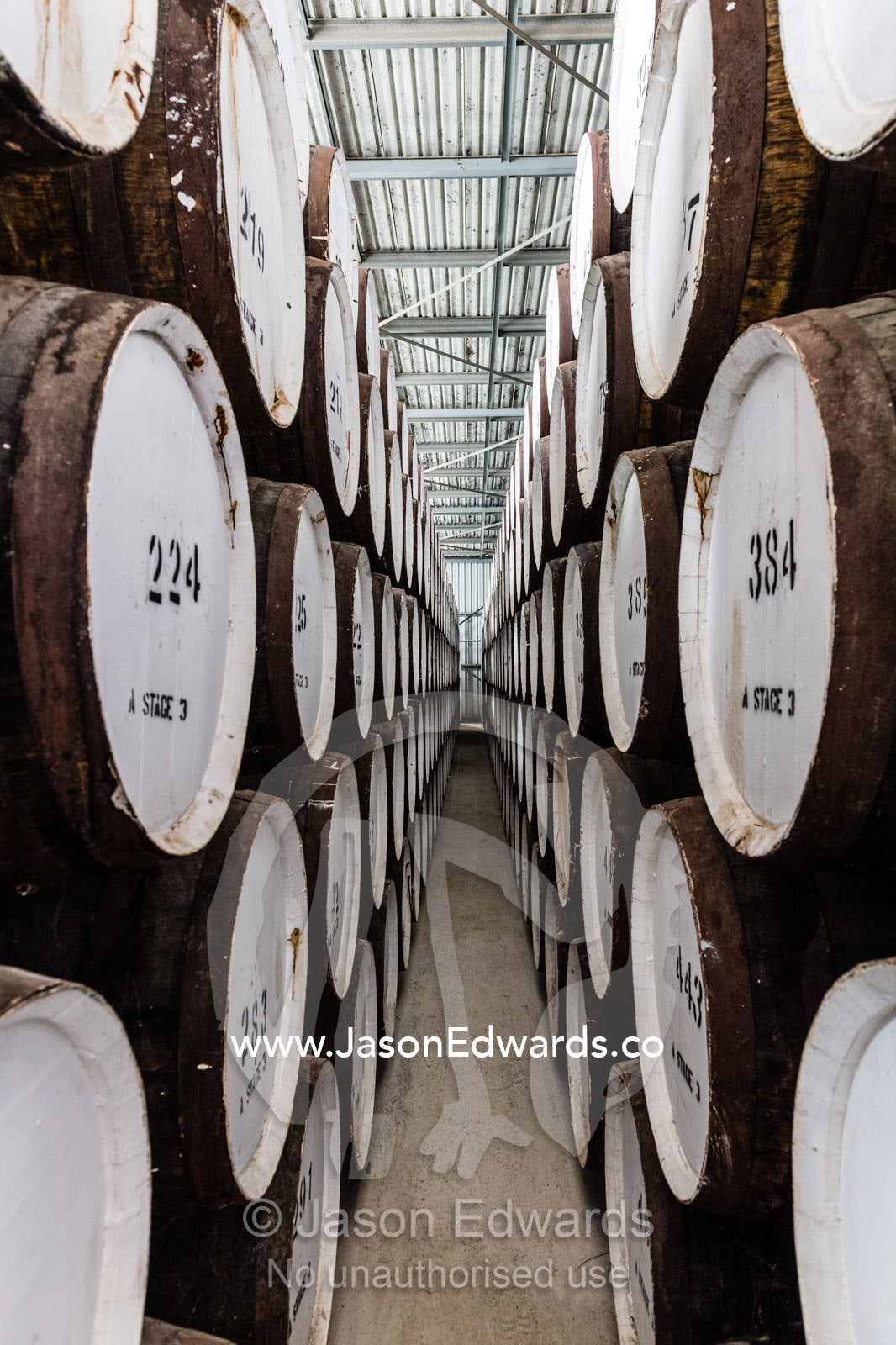 An enormous collection of wine barrels stacked and stored in a shed to age and mature. Nuriootpa, South Australia, Australia