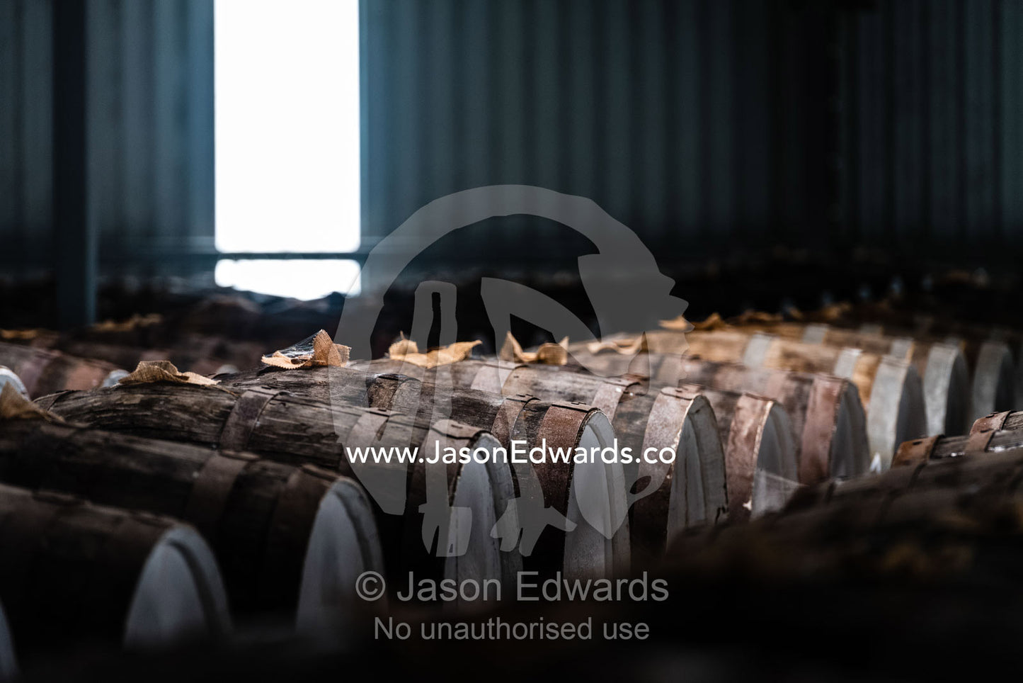 An enormous collection of wine barrels stacked and stored in a shed to age and mature. Nuriootpa, South Australia, Australia