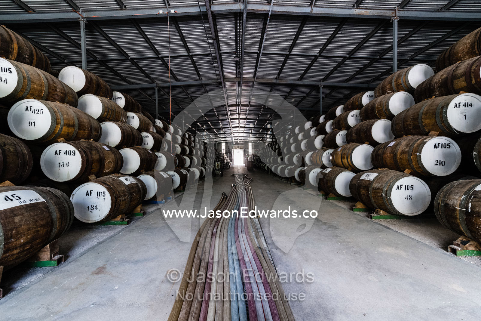 An enormous collection of wine barrels stacked and stored in a shed to age and mature. Nuriootpa, South Australia, Australia