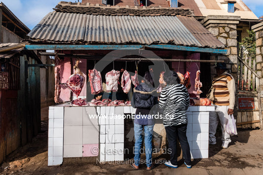 An open air butcher stall selling racks of meat in a street. Antananarivo, Madagascar