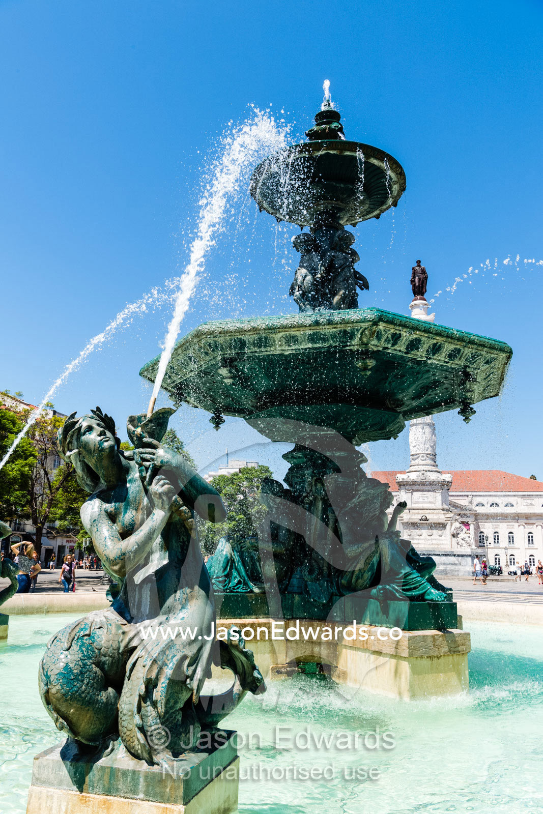 Water shoots from the mermaids in Fonts do Rossio fountain in Pedro IV Square. Lisbon, Lisboa, Portugal