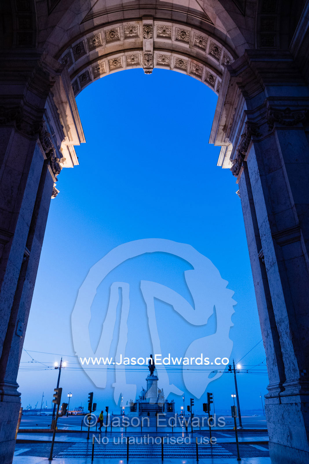 Looking through the Rua Augusta Arch at the bronze Statue of King John I in the pre-dawn light. Lisbon, Lisboa, Portugal