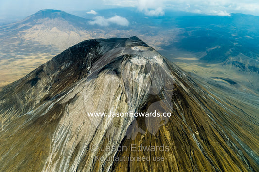 Erosion carves valleys into ash and lava flows on the slopes of a primeval volcano caldera. Crater Highlands, Ngorongoro Hig, African Rift Valley , Serengeti National Park, Tanzania