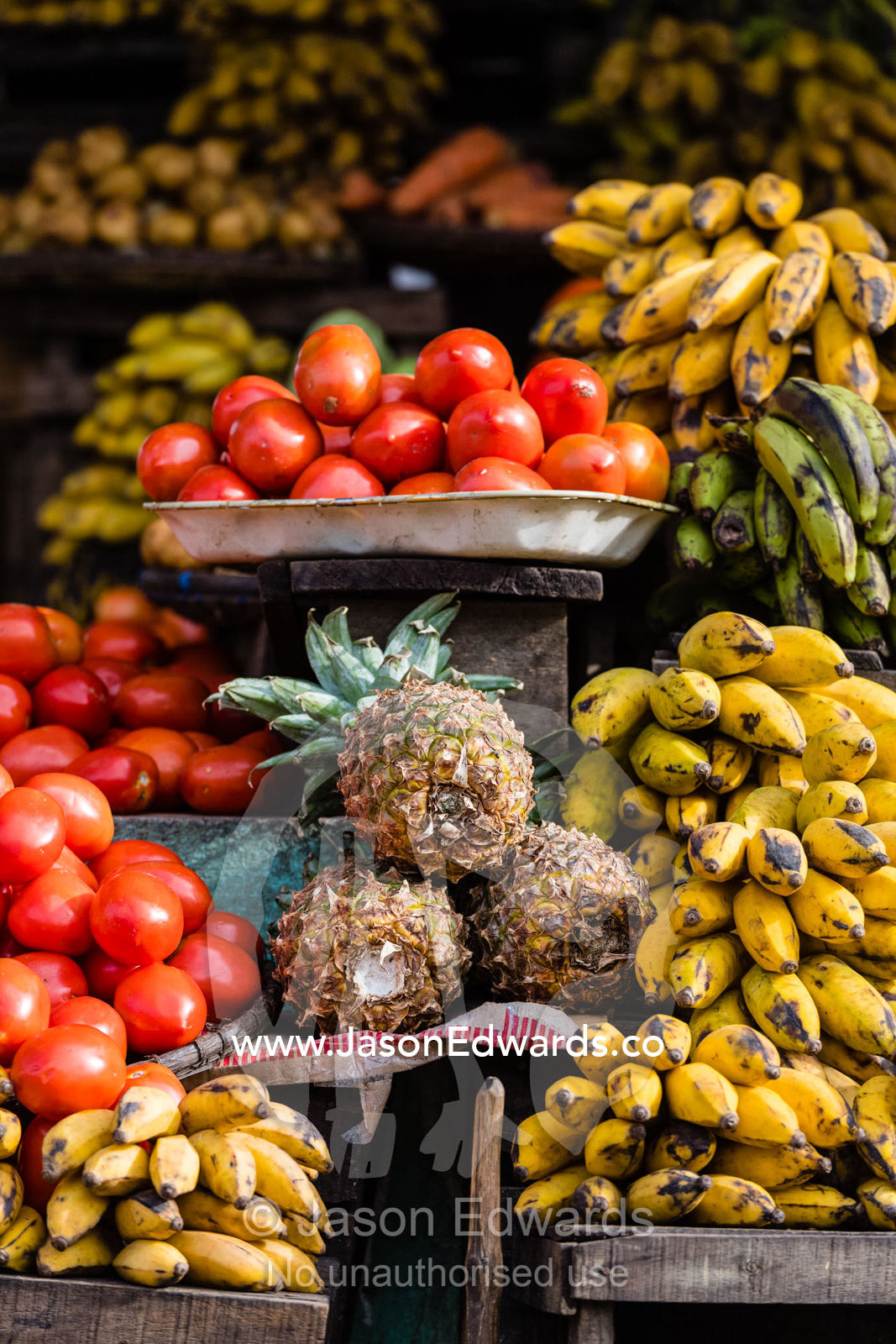 Organic pineapple, tomato and banana for sale in a village market. Andasibe, Madagascar