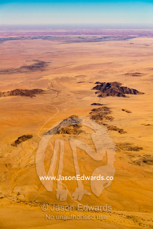 An aerial view of a desert track winding it's way through sand dunes. Walvis Bay, Namibia