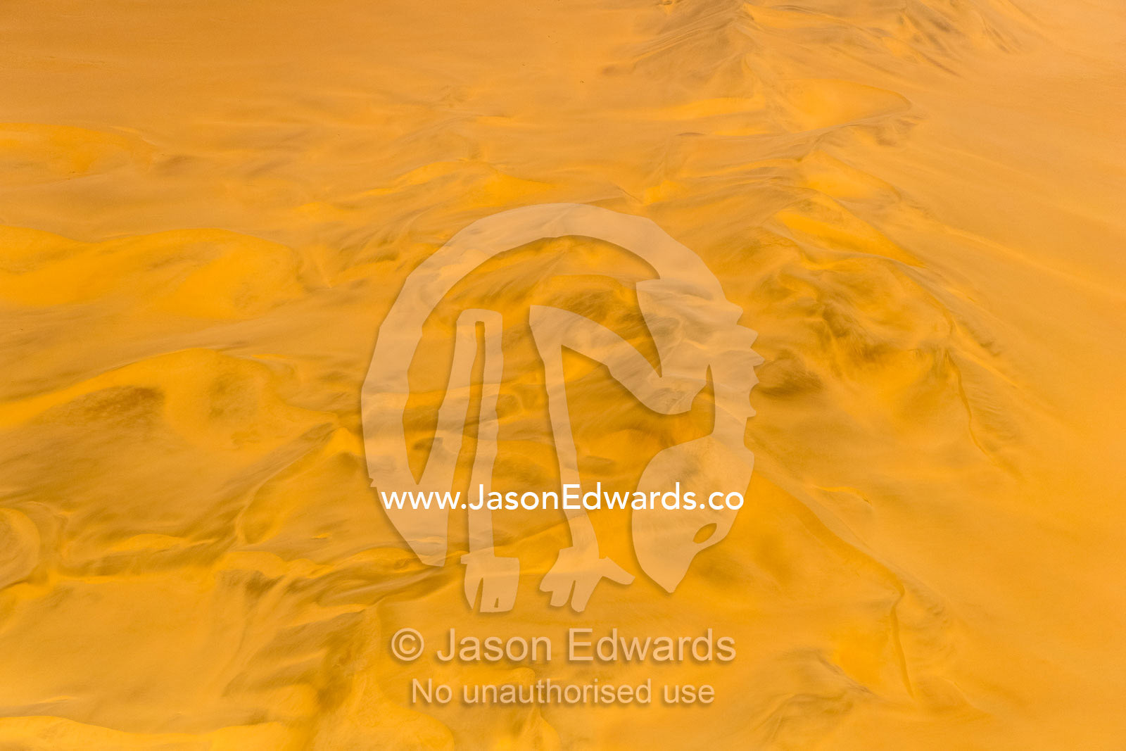 An aerial view of a sea of sand dunes disappearing into the distant horizon. Namib-Naukluft National Park, Namibia