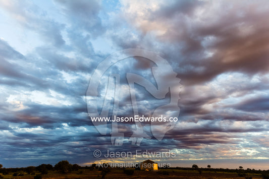 Storm clouds roll in over a shearing shed on an outback sheep station in the desert. Coober Pedy, Mt Willoughby Station, South Australia, Australia