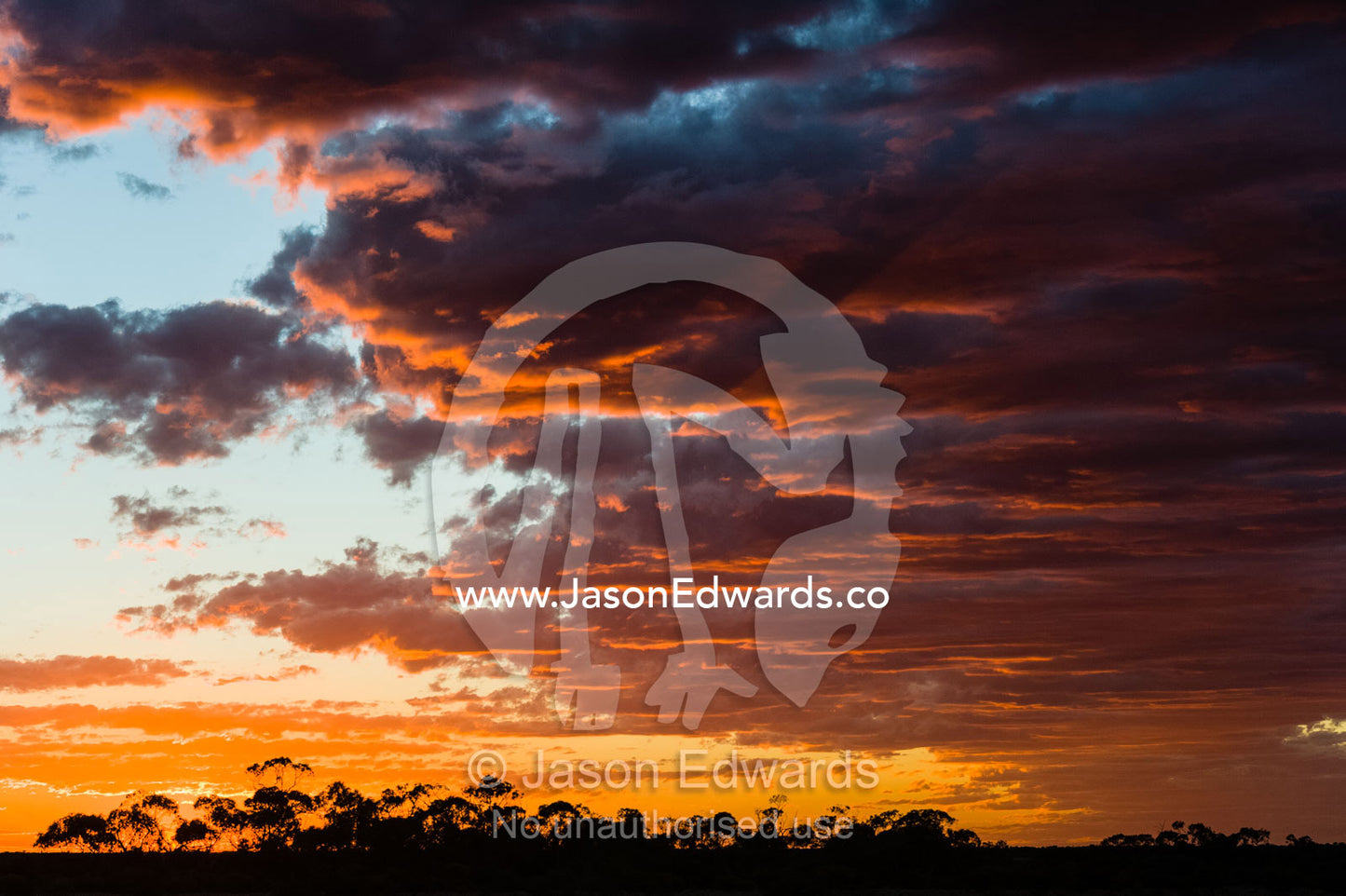 Sunset illuminates storm clouds forming over the outback desert plain. Coober Pedy, Mt Willoughby Station, South Australia, Australia