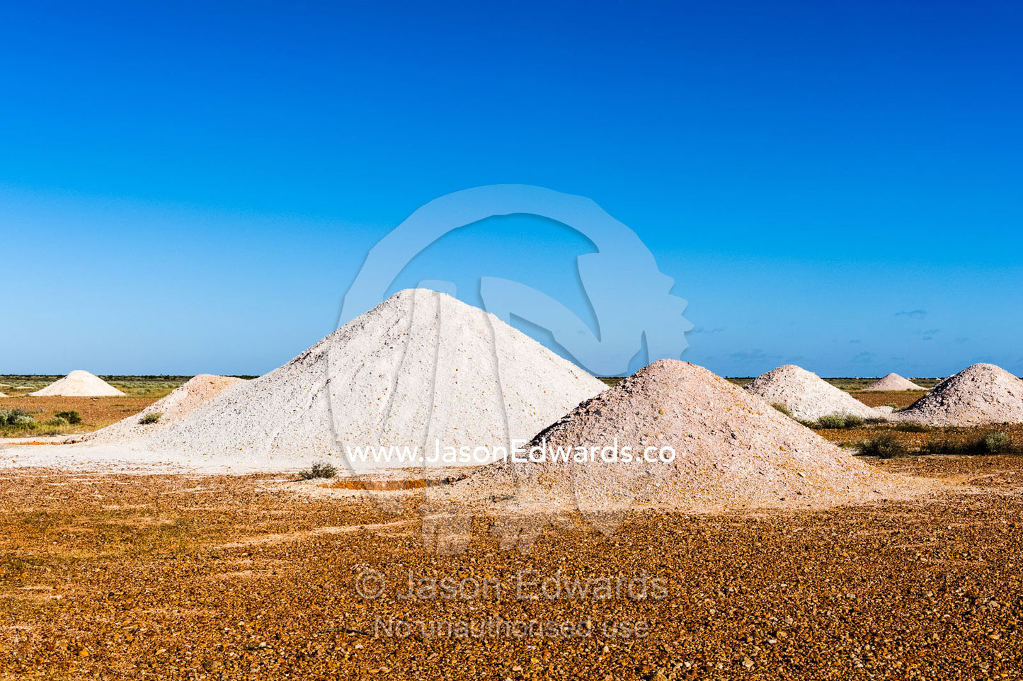 Slurry mounds surround the entrance to opal mine shafts in the desert. Coober Pedy, South Australia, Australia