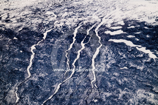 Rivers of snow and ice flow down a barren mountainside like snakes in the arctic. Scoresby Sound, Greenland