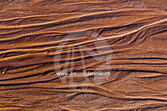 Textured patterns in beach sand from water leaching from the tundra in the arctic. Northeast Greenland National par, Harefjord, Hare Fjord, Rype Fjor, Scoresby Sound, Greenland