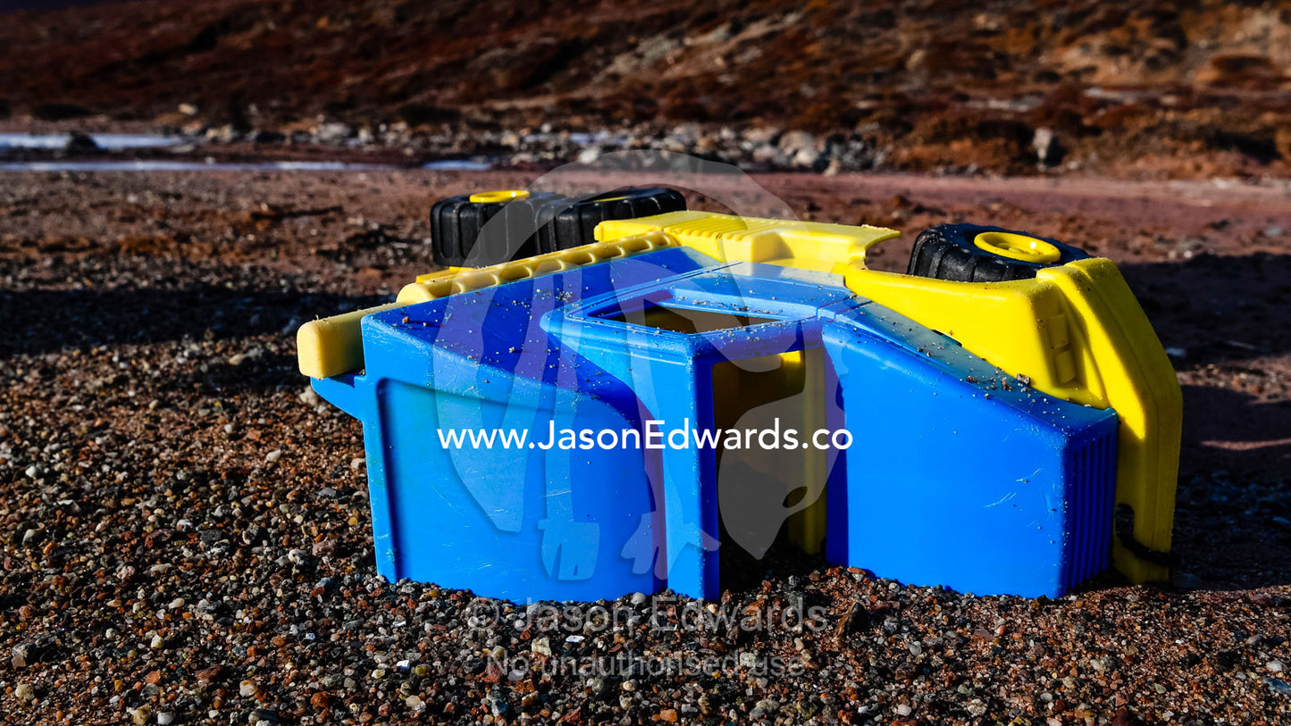 A plastic toy truck washed onto a remote beach in an arctic fjord. Northeast Greenland National par, Harefjord, Hare Fjord, Rype Fjor, Scoresby Sound, Greenland