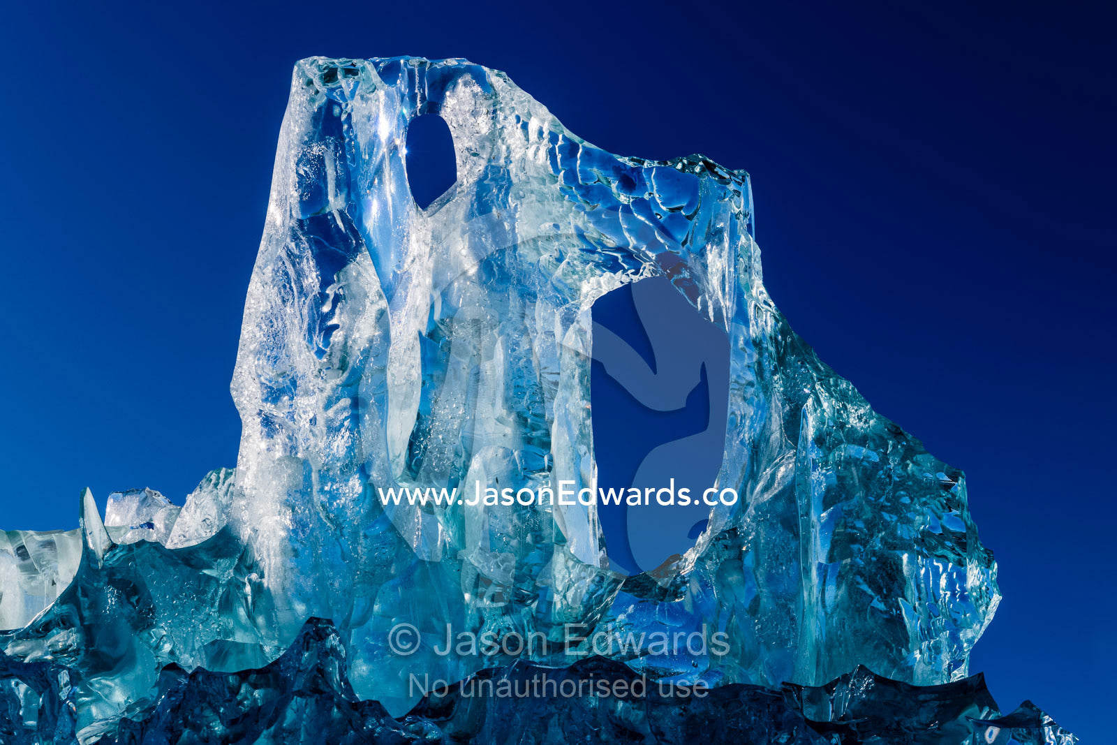 The glass-like sculpture of a crystalline iceberg created under pressure. Rolinge Glacier, Rode Fjord, Scoresby Sound, Greenland