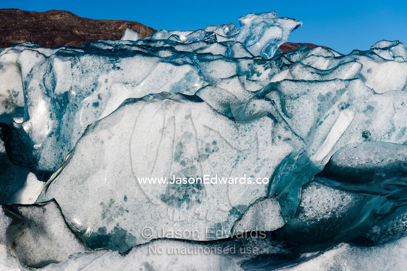 The glass-like sculpture of a crystalline iceberg created under pressure. Rolinge Glacier, Rode Fjord, Scoresby Sound, Greenland