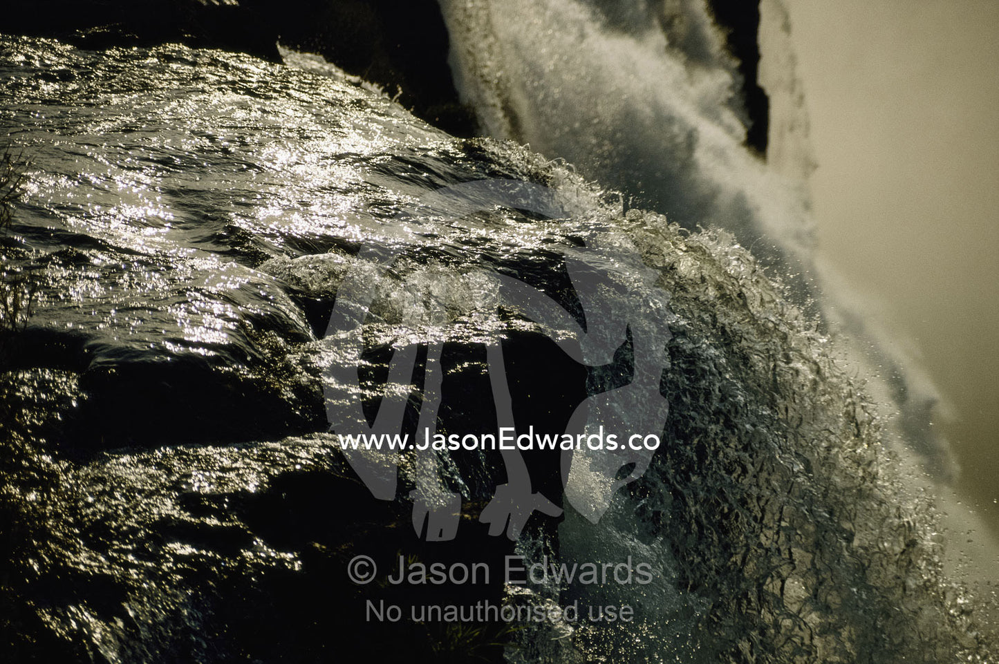 Close view of water cascading off rock at Victoria Falls. Victoria Falls, Zimbabwe, Africa.