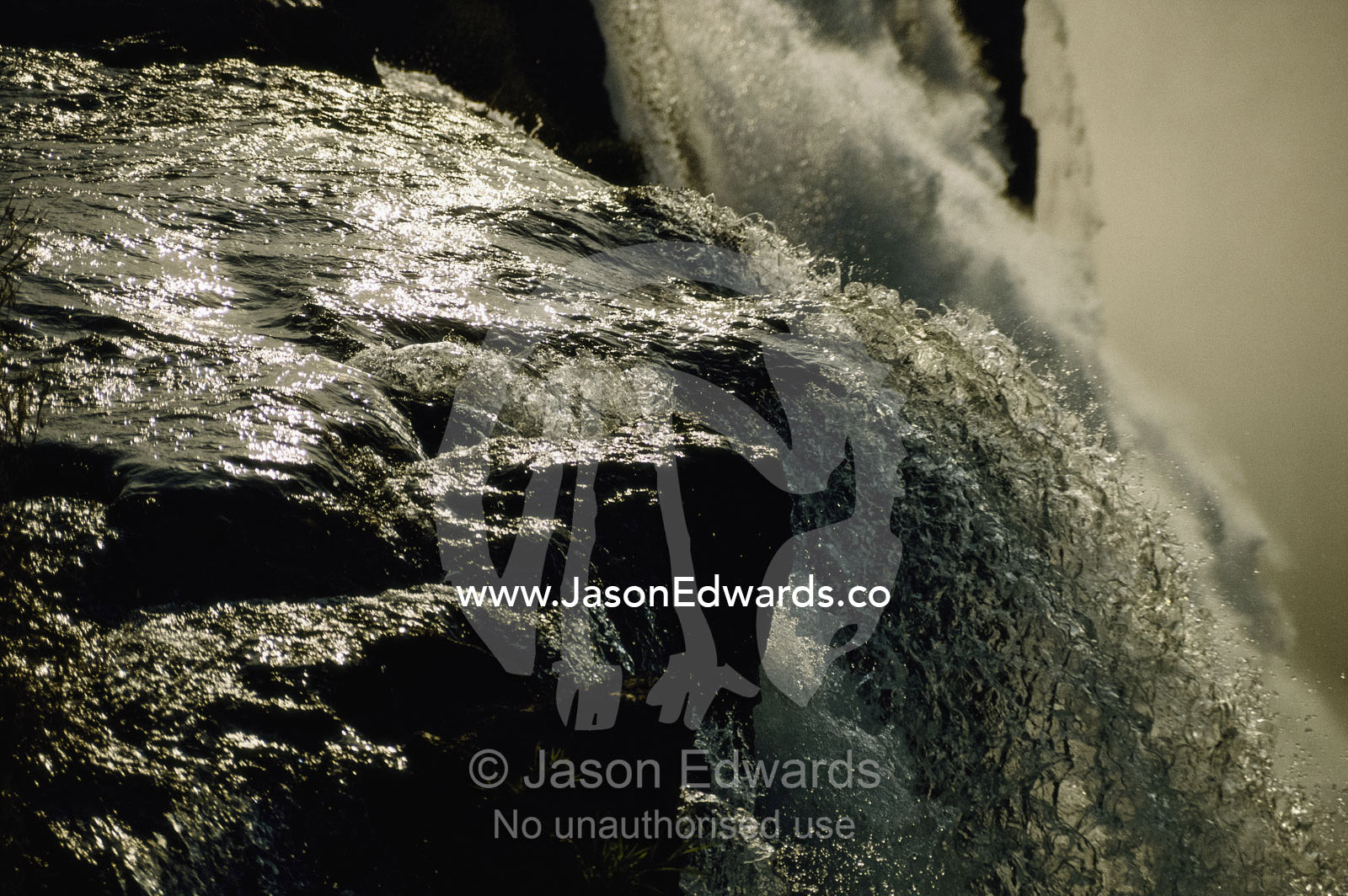 Close view of water cascading off rock at Victoria Falls. Victoria Falls, Zimbabwe, Africa.