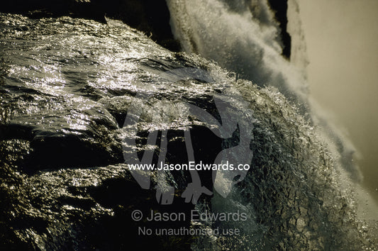 Close view of water cascading off rock at Victoria Falls. Victoria Falls, Zimbabwe, Africa.