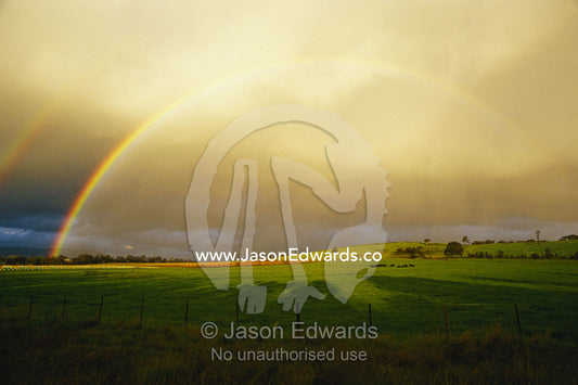 A double rainbow arcs over farmland and vineyards in the Yarra Valley. Yarra Valley, Victoria, Australia.