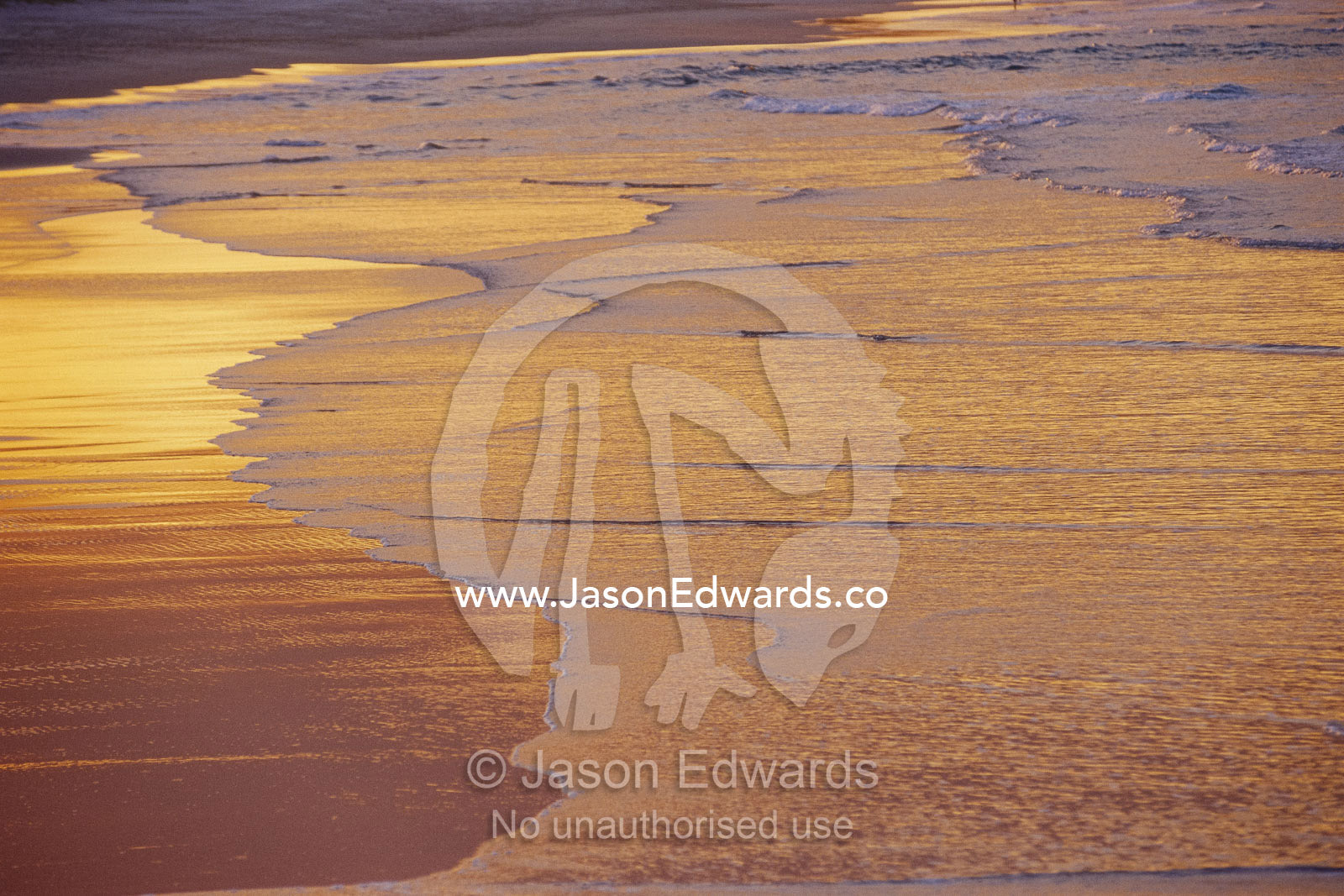 Sunlight reflected on an ebbing tide. Noosa, Queensland, Australia.