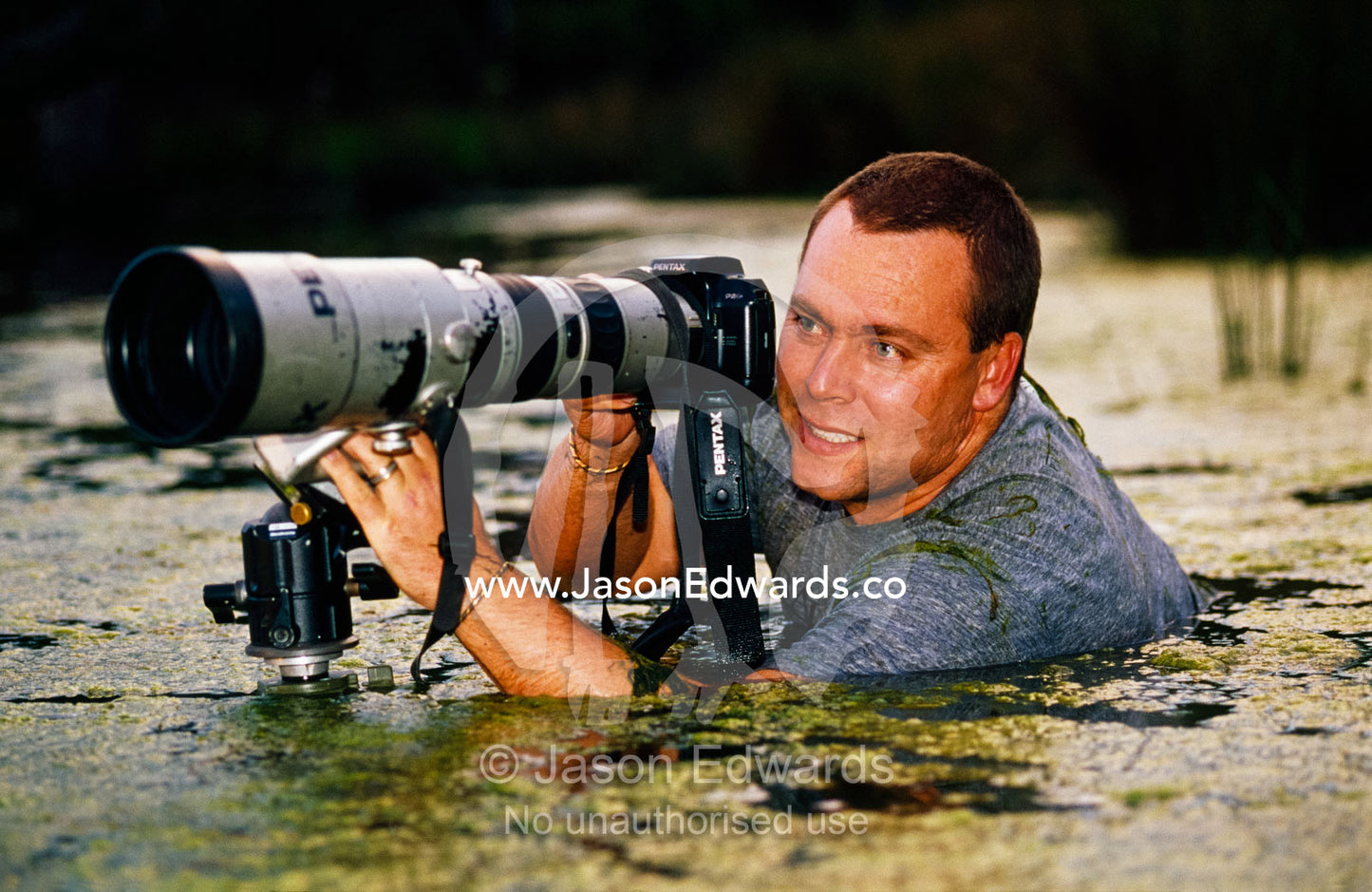 Jason Edwards photographing in wetlands. Corrandurk Wetlands, Victoria, Australia.