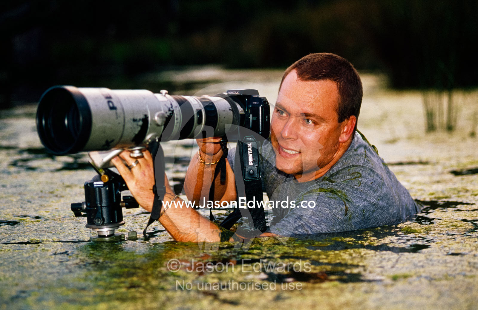 Jason Edwards photographing in wetlands. Corrandurk Wetlands, Victoria, Australia.