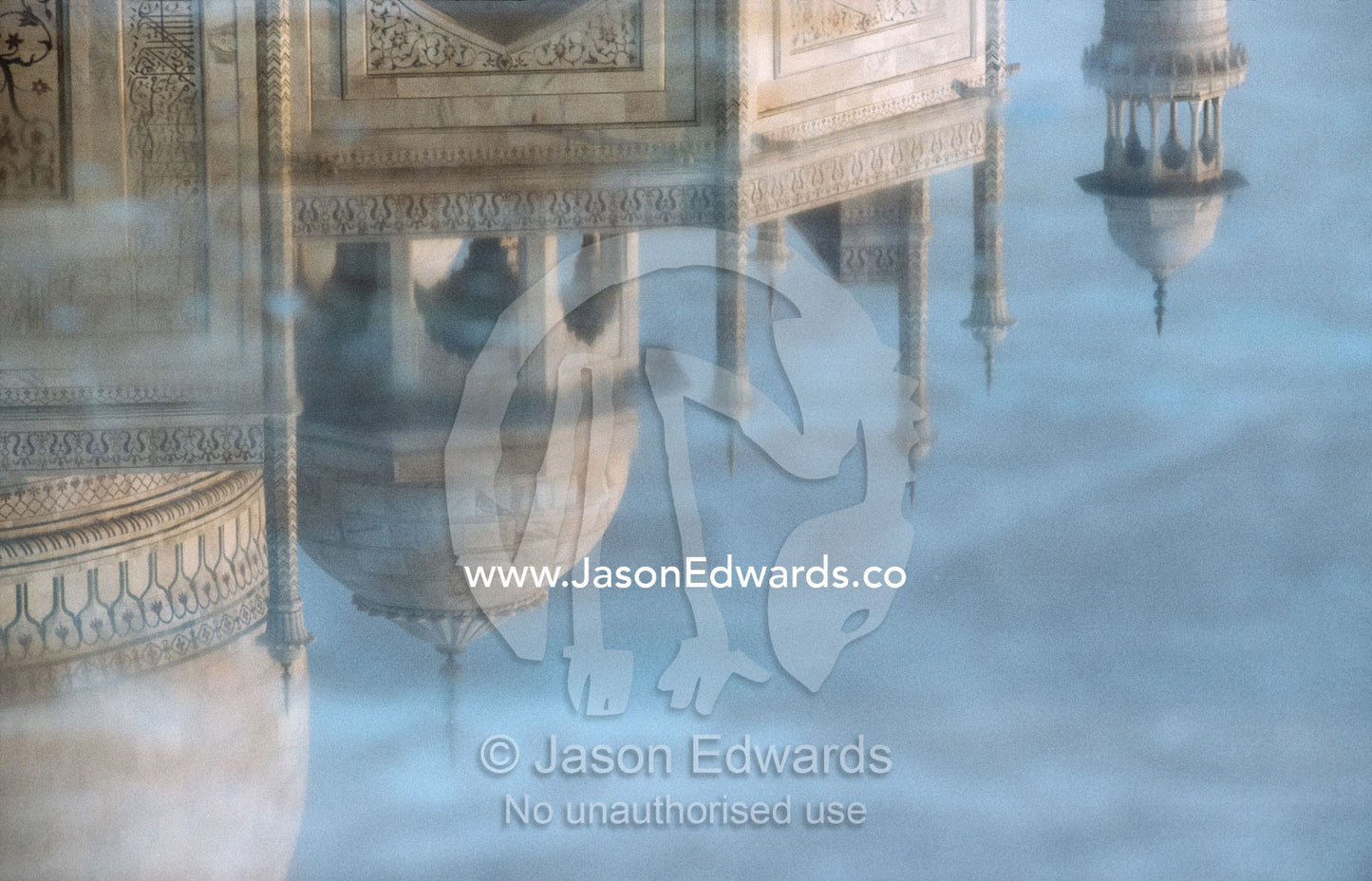 Marble domes of the Taj Mahal reflected on the surface of a pool. Taj Mahal, Agra, India.