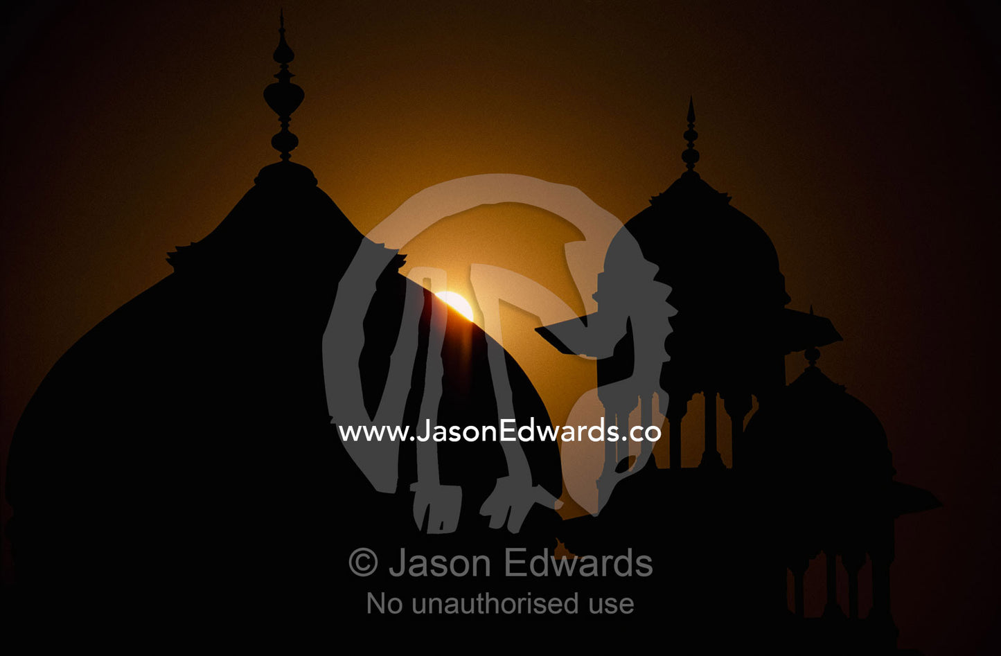 Silhouetted dome and turrets of the mosque adjacent to the Taj Mahal. Agra, Uttar Pradesh State, India.