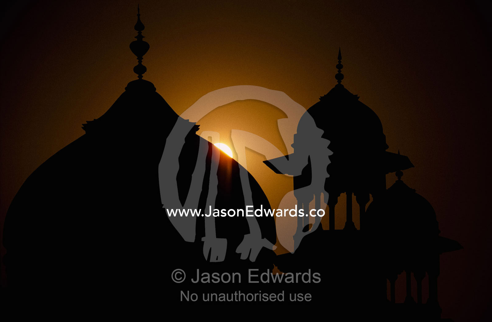 Silhouetted dome and turrets of the mosque adjacent to the Taj Mahal. Agra, Uttar Pradesh State, India.