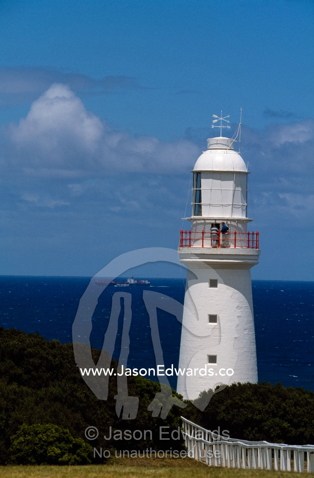 A ship passes Cape Otway Lightstation. Cape Otway Lightstation, Victoria, Australia.