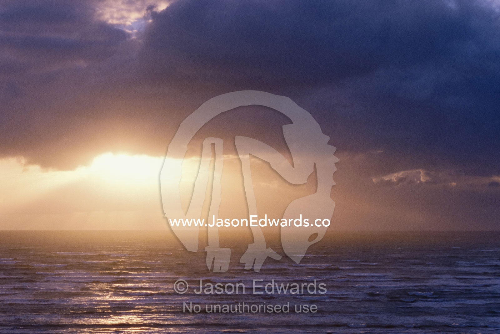 Sunlight bursts through clouds over the Southern Ocean. Coorong National Park, South Australia, Australia.
